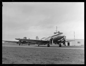 View of two Dakota transport planes parked in front of the control tower at Harewood Airport, Christchurch City, Canterbury Region