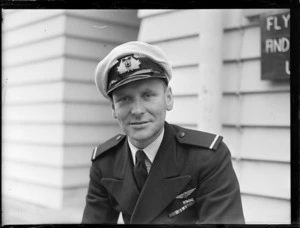 Portrait of NZ NAC ((National Airways Corporation) 2nd Officer Pilot D F C Barclay in uniform outside the [NAC?] building at Harewood Airport, Christchurch City, Canterbury Region