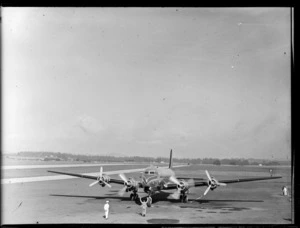TAA (Trans Australian Airways) Skymaster DC4 passenger plane 'Thomas Mitchell' taxiing with unidentified ground crew at Whenuapai Airport, Auckland City