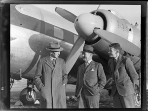 Portrait of (L to R) Mr Salmon, Mr Cory-Wright and John Cory-Wright standing in front of visiting British Vickers Viking passenger plane G-AJJN, Whenuapai Airport, Auckland City
