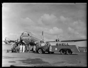 TAA (Trans Australian Airways) Skymaster DC4 passenger plane 'Thomas Mitchell' being refuelled with Shell Aviation Fuel by unidentified ground crew at Whenuapai Airport, Auckland City