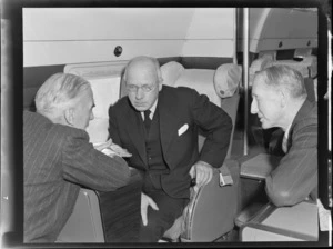 Group portrait of (L to R) Mr Dickson, NZ Prime Minister Peter Fraser and Mr Salmon, sitting on a flight to Wellington on visiting British Vickers Viking passenger plane G-AJJN