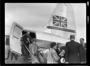 Mr and Mrs Maurice Clarke disembarking visiting British Vickers Viking passenger plane G-AJJN with other unidentified people, [Paraparaumu Airfield, Wellington Region?]