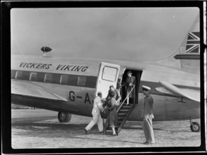 Unidentified passengers disembarking from visiting British Vickers Viking passenger plane G-AJJN demonstration flight at Paraparaumu Airfield, Wellington Region