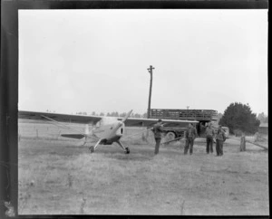 Auster ZK-AOB airplane, Sherwood Downs, Fairlie, Canterbury Region, including unidentified men and a cattle truck