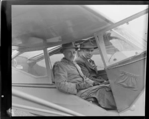 Auster tours, showing R Gardner (Dunedin) and D Greig (right) inside an Auster aircraft, location unidentified