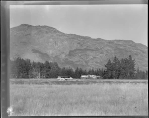 An Auster ZK-AOB airplane, on a field, Queenstown, including hills in the background