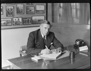 Portrait of Sir Leonard Isitt, sitting at desk