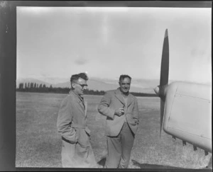Auster tour, showing T Ewart (left) and M Wells, Irishman's Creek, Mackenzie Dirict, Canterbury, looking at the front nose propellar of an Auster airplane