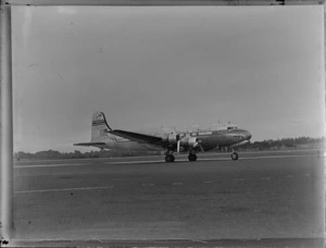 View of PAWA Clipper Oriental NC 88957 passenger plane on the runway, [Whenuapai Airfield, Auckland?]