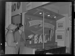 View of a TEAL travel display with an unidentified man and woman looking on, Whangarei Winter Show, Northland Region