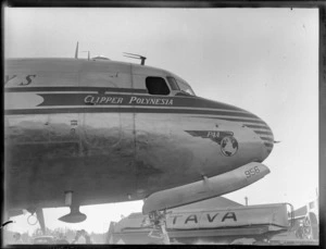 Nose-view of PAA's Douglas DC 4 Clipper Polynesia CN 88956 passenger plane being refuelled at [Whenuapai Airfield, Auckland?]