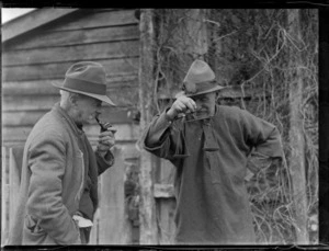 Goldmining, view of 'pioneer beachcombers' Bell and Ted Bagley using handheld gold scales, South Westland, West Coast Region
