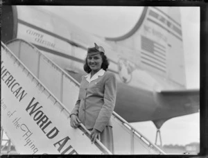 Portrait of PAA Stewardess Patricia Meek descending PAWA boarding stairs from of PAA Clipper Celestial NC 88959 passenger plane, Whenuapai Airfield, Auckland