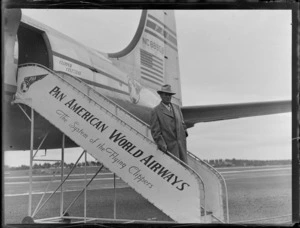 Portrait of Mr Frank Ross descending PAWA boarding stairs from PAA Clipper Celestial NC 88959 passenger plane, Whenuapai Airfield, Auckland