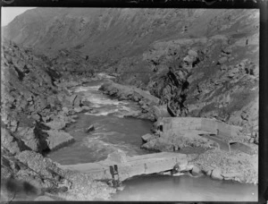 Goldmining, view of the Kawarau River with footbridge and walkway passed old gold mining structure, Central Otago Region