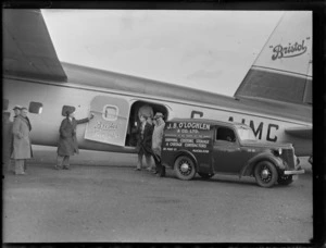 View of a J B O'Loghlen and truck with unidentified people in front of the B170 Mk1 transport plane 'Bristol' Freighter G-AIMC, Whenuapai Airfield, Auckland