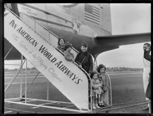 Group portrait of unidentified children on PAWA boarding steps of PAA Clipper Celestial NC 88959 passenger plane, Whenuapai Airfield, Auckland