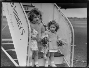Portrait of the Rouda family children on PAWA boarding steps prior to departing on PAA Clipper Celestial NC 88959 passenger plane, Whenuapai Airfield, Auckland