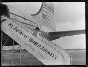 Portrait of Miss Dorothy Lesley Nicholson boarding PAA Clipper Celestial NC 88959 passenger plane, Whenuapai Airfield, Auckland