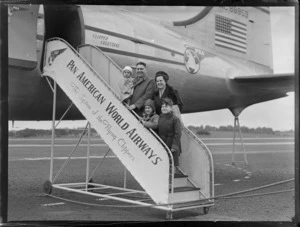 Portrait of Mr and Mrs England and family boarding PAA Clipper Celestial NC 88959 passenger plane, Whenuapai Airfield, Auckland
