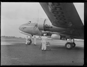 View of PAA Clipper Celestial NC 88959 passenger plane with unidentified ground crew and pilot prior to departure, Whenuapai Airfield, Auckland