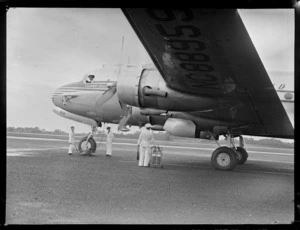 View of PAA Clipper Celestial NC 88959 passenger plane with unidentified ground crew and pilot prior to departure, Whenuapai Airfield, Auckland