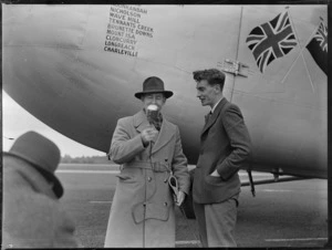View of 1ZB Reporter Dudley Wrathall interviewing Bristol Sales Representative M F Elliott in front of visiting Bristol Freighter transport plane 'Merchant Venturer' G-AIMC, Whenuapai Airfield, Auckland