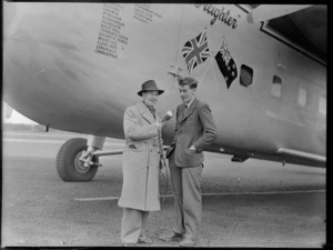 View of 1ZB Reporter Dudley Wrathall interviewing Bristol Sales Representative M F Elliott in front of visiting Bristol Freighter transport plane 'Merchant Venturer' G-AIMC, Whenuapai Airfield, Auckland