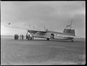View of a group of unidentified men with the visiting Bristol Freighter transport plane 'Merchant Venturer' G-AIMC, Whenuapai Airfield, Auckland