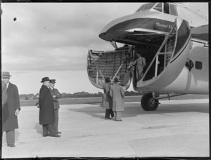 View Mr J A C Allum (Mayor of Auckland) and of Mr T O'Connell in uniform viewing visiting Bristol Freighter transport plane 'Merchant Venturer' G-AIMC with front cargo doors open, Whenuapai Airfield, Auckland