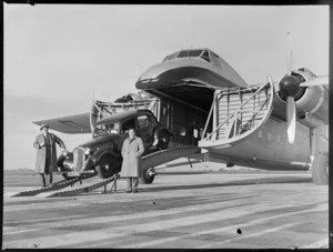 Mr N Higgs' car emerging from Bristol Freighter airplane, Whenuapai airport, Auckland area