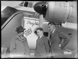 Portrait of (L to R) two unidentified men and Mr Barker (NZ Railways) in front of visiting Bristol Freighter transport plane 'Merchant Venturer' G-AIMC, Whenuapai Airfield, Auckland City
