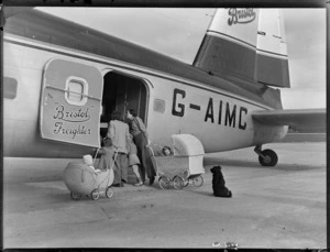 Two unidentified women with children, including babies in prams, looking into a Bristol Freighter G-AIMC aircraft, Whenuapai, Auckland