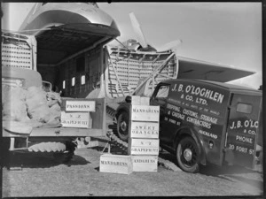 J B O'Loghlen and Company Limited truck delivering wooden cases of fruit, including passions, grapefruit, mandarins, sweet oranges, grapefruit and mandarins, aboard a Bristol Freighter, Kaikohe