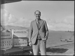 Mr A R Emanuel, Chairman of Kerikeri fruitgrowers Association, including wooden fruit crates being shipped in a Bristol Freighter, which visited Kaikohe
