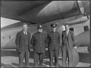 Constable J King (from left), Constable H Alsop, Traffic Inspector R Peters & E Tyler, Clerk of Court, in front of a Bristol Freighter aircraft, Kaikohe