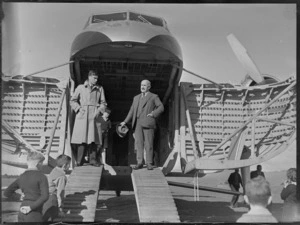 Two unidentified men standing inside a Bristol Freighter aircraft, Kaikohe, including children in the foreground