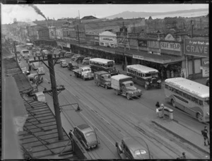Wakefield Castrol Oil photographs, showing street scene in Newmarket, Auckland, including shops, buses, motorcars and Rangitoto Island in the background