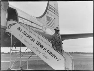 Mr Frank Ross walking down a gateway, departing a PAWA (Pan American World Airways) Clipper Celestial NC88959 aircraft, location unidentified
