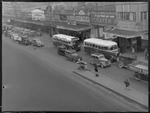 Wakefield Castrol Oil photographs, showing street scene at Newmarket, Auckland, including shops, buses and motorcars