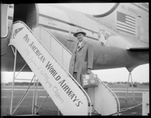 Mr Enright, standing on a gateway on arrival of a PAA (Pan American Airways) Clipper Kathay NC88883 aircraft, location unidentified