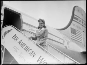Miss G Spaulding, stewardess PAA (Pan American Airways), on gateway leading to a Clipper Kathay NC88883 aircraft, location unidentified