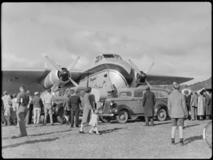 Bristol Freighter tour, Rotorua, showing crowd of people viewing a Bristol Freighter 'Merchant Venturer' aircraft, being refuelled