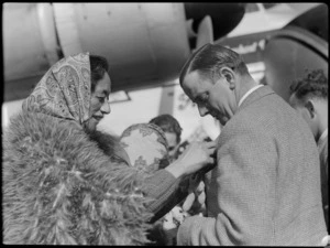 Captain R Ellison being presented with miniature pois by guide Rangi, at the Bristol Freighter Tour, Rotorua, Bay of Plenty