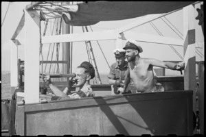 Lieutenant H L Mallitte and crew watching results of practice shoot on a World War II minesweeper in Adriatic Sea - Photograph taken by George Bull