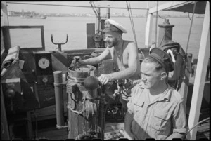 Lieutenant H L Mallitte and Signalman R Geraghty on bridge of World War II minesweeper entering port at Bari, Italy - Photograph taken by George Bull