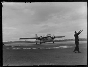 View of the arrival of Bristol Freighter transport plane 'Merchant Venturer' G-AIMC, Whenuapai Airfield, Auckland