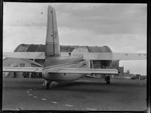 Tail view of the visiting Bristol Freighter transport plane 'Merchant Venturer' G-AIMC in front of airport buildings, Whenuapai Airfield, Auckland