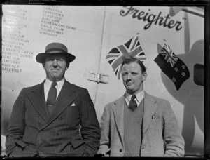 Portrait of N Higgs and Captain R Ellison in front of Bristol Freighter transport plane 'Merchant Venturer' G-AIMC, Whenuapai Airfield, Auckland